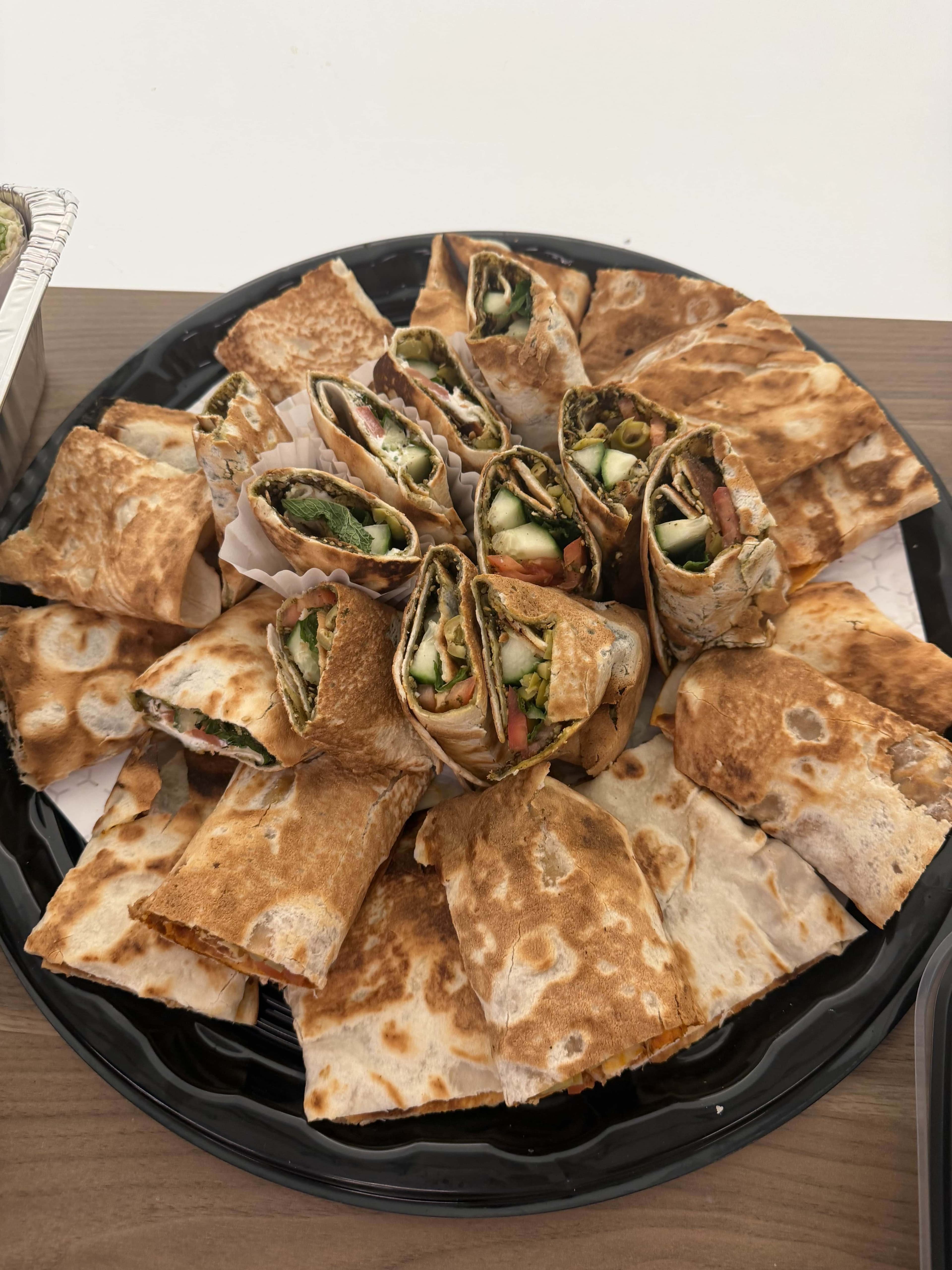 Beautifully arranged platter of Lebanese wraps and manoushe